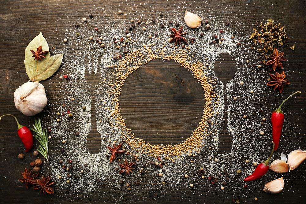 Spices on table shaping plate fork and spoon